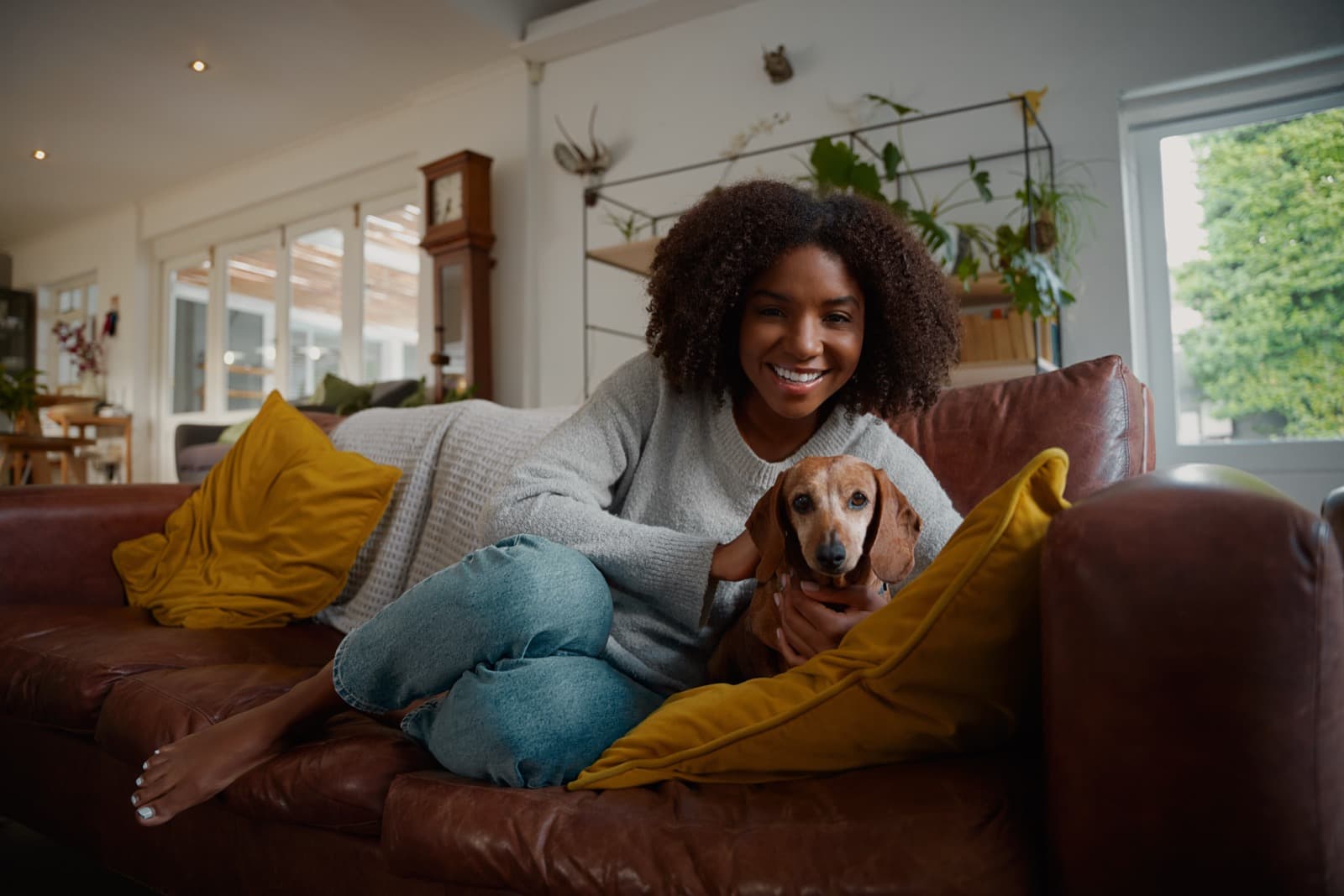 Pet parent relaxing at home with their dachshund